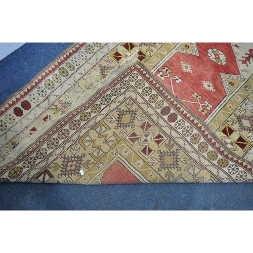 1326 - A PERSIAN MILAS RUG, cream and gold, and central red field, 190cm x 120cm (discolouration) and a Per... 