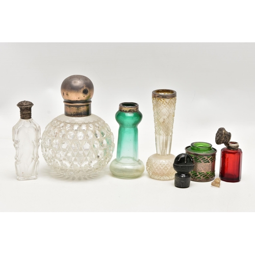 152 - A GROUP OF 19TH AND EARLY 20TH CENTURY SILVER AND WHITE METAL MOUNTED SCENT BOTTLES AND TOILET JARS ... 