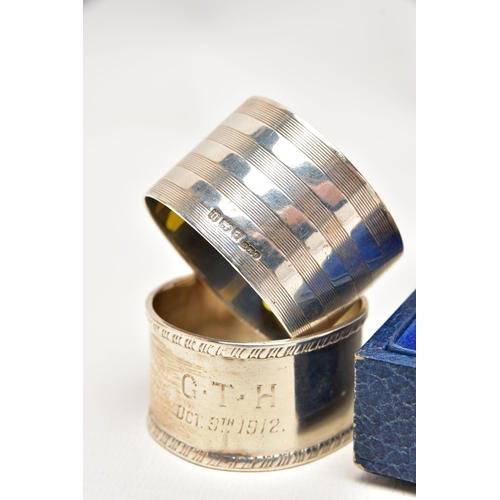 155 - A PAIR OF CASED GEORGE V SILVER CIRCULAR NAPKIN RINGS AND FIVE OTHER SILVER NAPKIN RINGS, the cased ... 