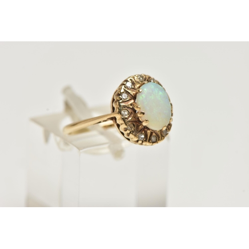 16 - A YELLOW METAL, OPAL AND DIAMOND CLUSTER RING, of an oval form, centring on an oval opal cabochon, r... 