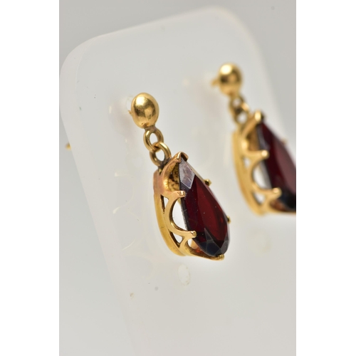 17 - A PAIR OF GARNET DROP EARRINGS, each set with a pear cut garnet drop, claw set into a yellow gold mo... 