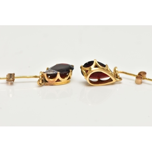 17 - A PAIR OF GARNET DROP EARRINGS, each set with a pear cut garnet drop, claw set into a yellow gold mo... 