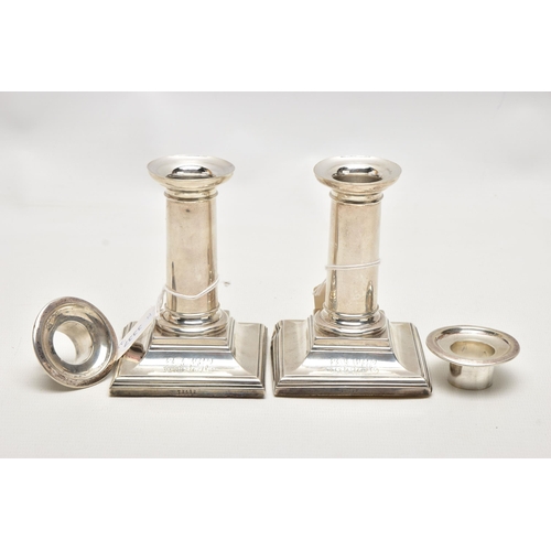 174 - A PAIR OF LATE VICTORIAN SILVER CANDLESTICKS, polished columns, on weighted square bases, engraved i... 