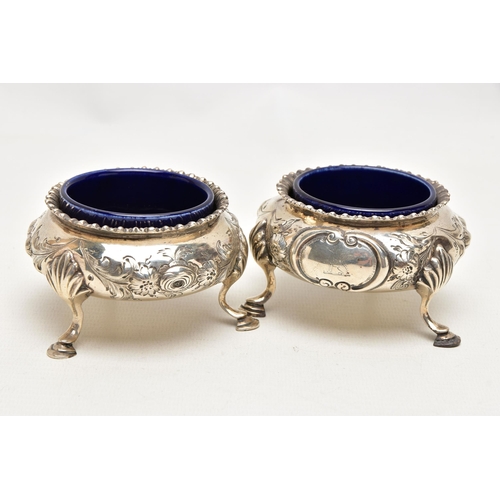 184 - A PAIR OF MID VICTORAIN SILVER SALTS, each of a cauldron form with an embossed floral design, shell ... 