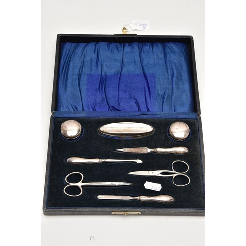 187 - AN EARLY 20TH CENTURY CASED SILVER MANICURE SET, case opens to reveal two small glass jars with silv... 