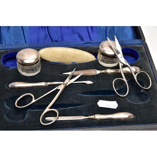 187 - AN EARLY 20TH CENTURY CASED SILVER MANICURE SET, case opens to reveal two small glass jars with silv... 