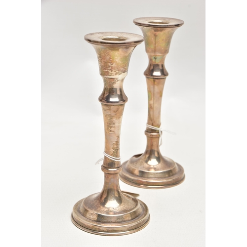 188 - A PAIR OF SILVER CANDLESTICKS, each with a tapered stem, on round weighted bases, approximate height... 