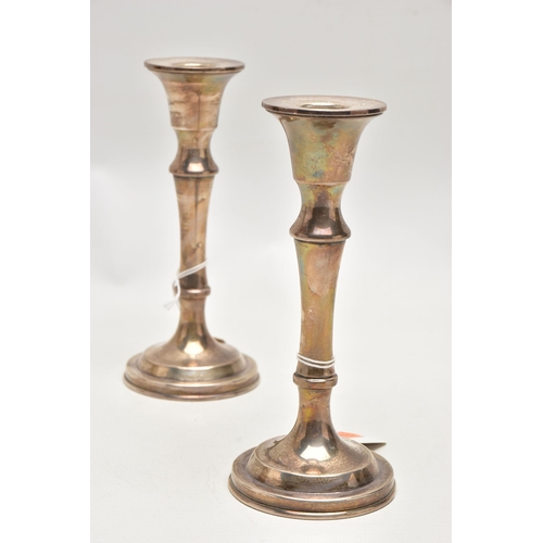 188 - A PAIR OF SILVER CANDLESTICKS, each with a tapered stem, on round weighted bases, approximate height... 