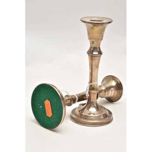 188 - A PAIR OF SILVER CANDLESTICKS, each with a tapered stem, on round weighted bases, approximate height... 