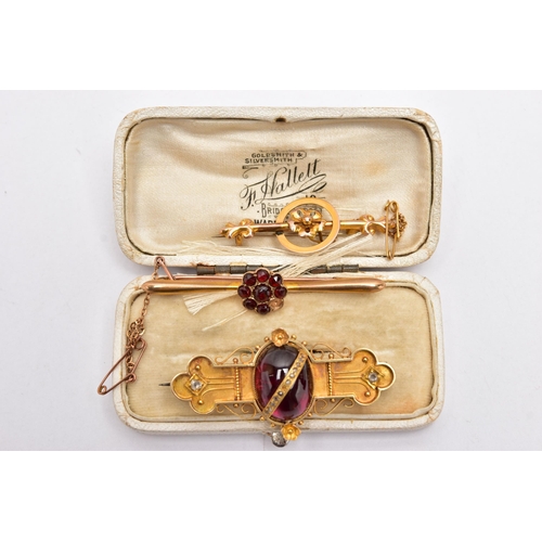 49 - THREE LATE VICTORIAN YELLOW METAL BROOCHES, the first set with a garnet cabochon to the centre, deta... 