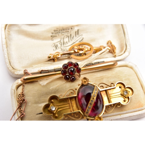 49 - THREE LATE VICTORIAN YELLOW METAL BROOCHES, the first set with a garnet cabochon to the centre, deta... 