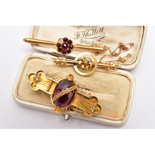 49 - THREE LATE VICTORIAN YELLOW METAL BROOCHES, the first set with a garnet cabochon to the centre, deta... 