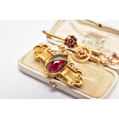 49 - THREE LATE VICTORIAN YELLOW METAL BROOCHES, the first set with a garnet cabochon to the centre, deta... 