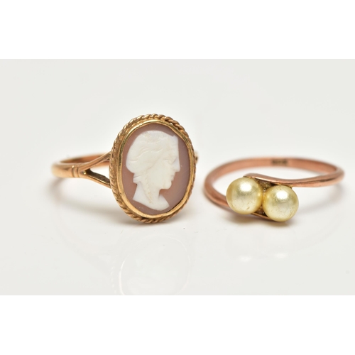 56 - TWO GEM SET RINGS, the first a yellow metal ring set with two imitation pearls in a bypass mount, st... 