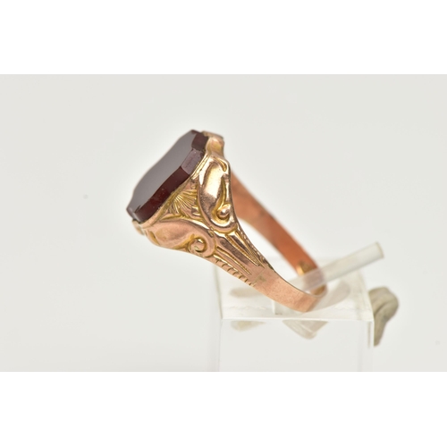 6 - A 9CT GOLD EARLY 20TH CENTURY SIGNET RING, rose gold set with a polished shield shape carnelian inla... 