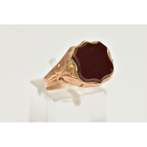 6 - A 9CT GOLD EARLY 20TH CENTURY SIGNET RING, rose gold set with a polished shield shape carnelian inla... 