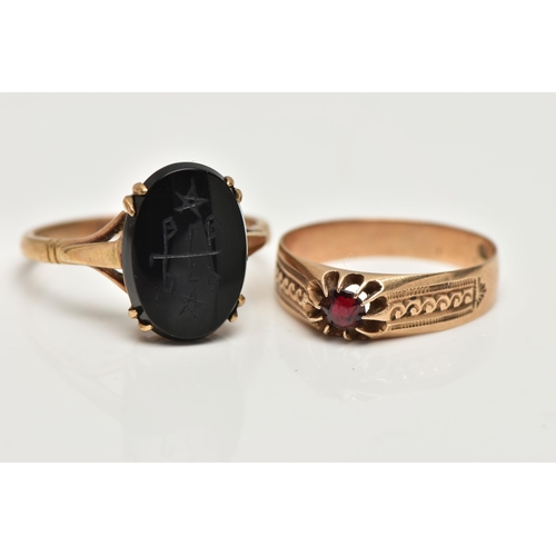 60 - TWO GEM SET RINGS, the first an oval onyx with carved detail, prong set in yellow metal, trifurcated... 