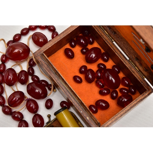 68 - A SMALL WOODEN BOX WITH BAKELITE BEADS AND TWO CHEROOTS, the small wooden box with a painted hinged ... 