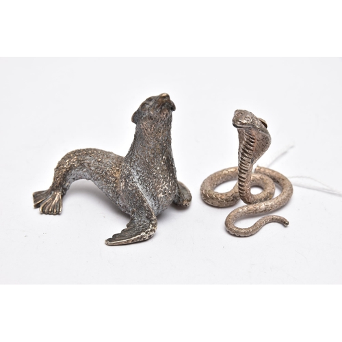 71 - TWO WHITE METAL FIGURINES, the first a white metal python snake, decorated with a textured detail, a... 