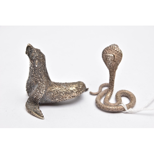 71 - TWO WHITE METAL FIGURINES, the first a white metal python snake, decorated with a textured detail, a... 