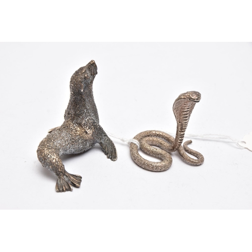 71 - TWO WHITE METAL FIGURINES, the first a white metal python snake, decorated with a textured detail, a... 