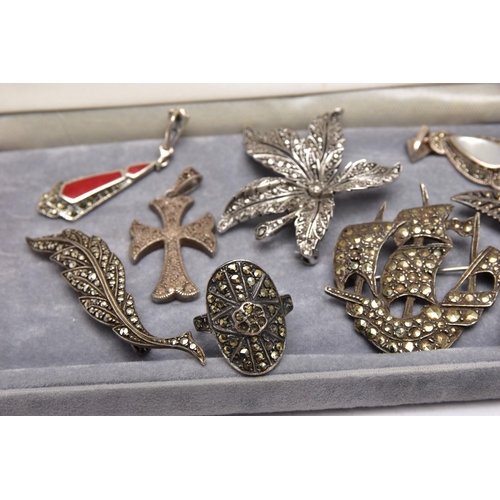 74 - AN ASSORTMENT OF WHITE METAL JEWELLERY, to include four brooches, four pendants and two rings, most ... 