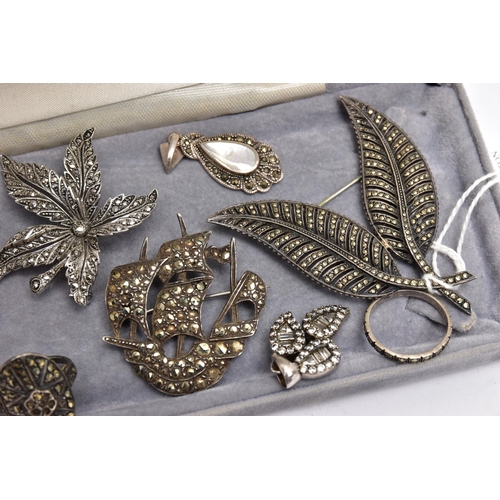 74 - AN ASSORTMENT OF WHITE METAL JEWELLERY, to include four brooches, four pendants and two rings, most ... 