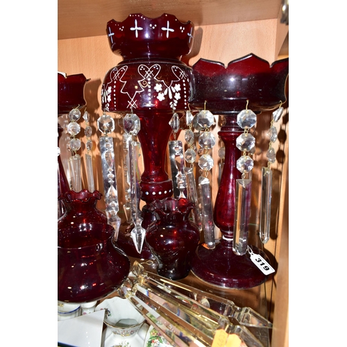 319 - THREE CRANBERRY GLASS LUSTRES, VASES AND SPARE LUSTRE DROPS, comprising a single cranberry glass lus... 