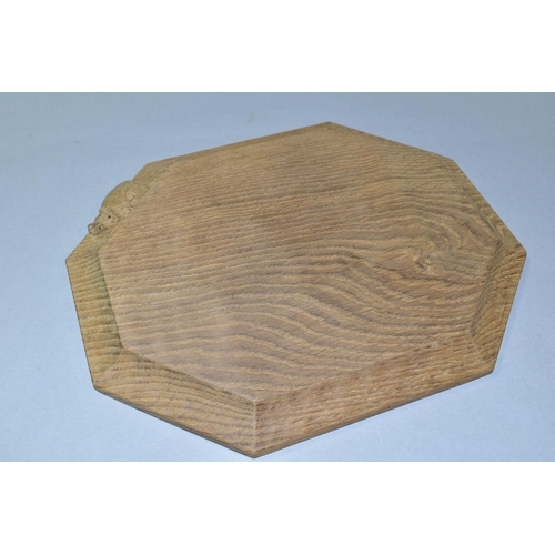 329 - A ROBERT 'MOUSEMAN' THOMPSON OAK BREAD BOARD, of octagonal form, modern and appears unused, approxim... 