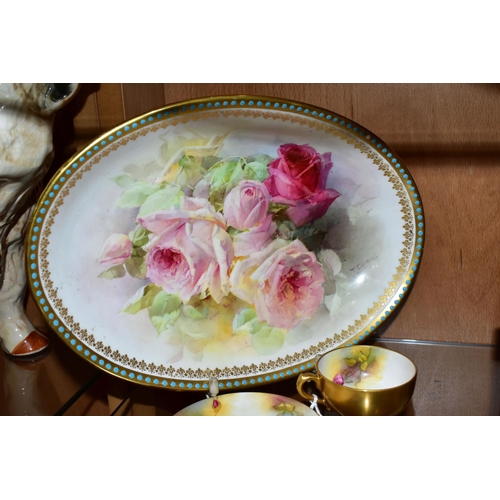 334 - A ROYAL WORCESTER TEACUP AND SAUCER, AND A ROYAL DOULTON BOWL, PAINTED WITH ROSES, the small teacup ... 