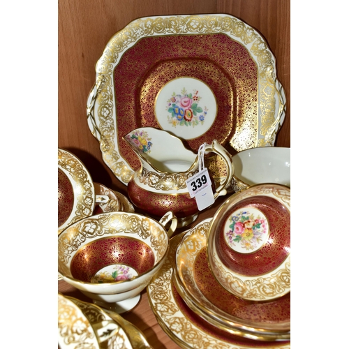 339 - A TWENTY ONE PIECE HAMMERSLEY TEA SET, in pattern 2396, with red and gilt borders around a central p... 