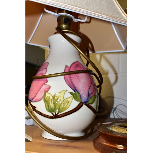 374 - A PAIR OF MOORCROFT POTTERY TABLE LAMPS, comprising two pink magnolia on cream ground lamp bases wit... 