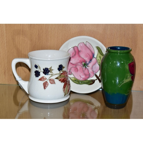 379 - A COLLECTION OF MOORCROFT POTTERY, comprising a 'Blackberry' pattern mug, height 9cm, designed by Sa... 