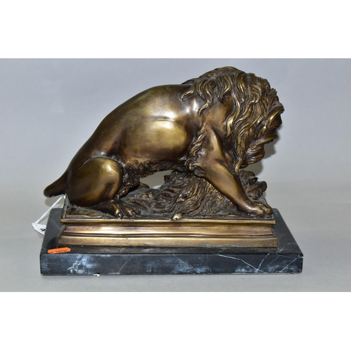 430 - A BRONZE STUDY OF A LION, seated with its kill - a wild boar, on a marble plinth, length 30cm x dept... 