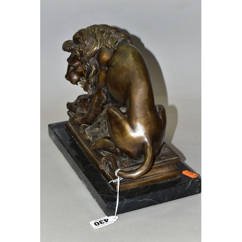 430 - A BRONZE STUDY OF A LION, seated with its kill - a wild boar, on a marble plinth, length 30cm x dept... 