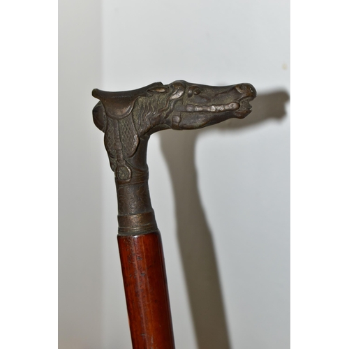 463 - A COLLECTION OF WALKING STICKS, HORSE CROP AND SWAGGER STICK, comprising a miliary swagger stick wit... 