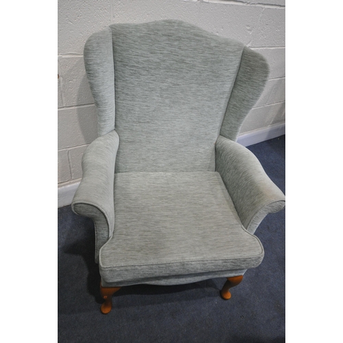 1328 - A MINT GREEN UPHOLSTERED WING BACK ARMCHAIR, and a glide motion rocking chair (condition - both in u... 