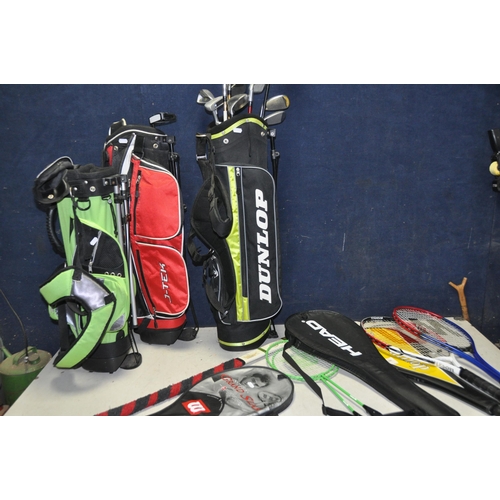 1083 - THREE JUNIOR GOLF BAGS containing various clubs such as Nike, Wilson, Dunlop, J-Tek and Masters and ... 