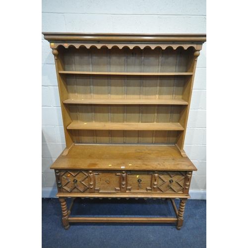 1202 - A REPRODUCTION OAK DRESSER, the top being a three tier plate rack, on a base with two deep drawers, ... 