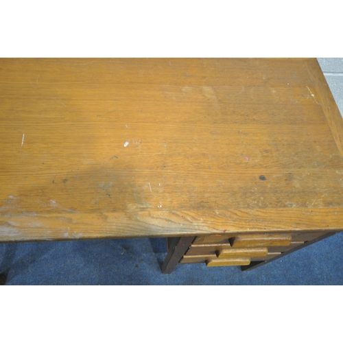 1204 - A 20TH CENTURY OAK DESK, with three drawers, and brushing slide, length 107cm x depth 51cm x height ... 