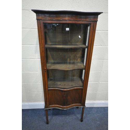 1212 - AN EDWARDIAN MAHOGANY SERPENTINE SINGLE DOOR DISPLAY CABINET, with a panel base, on square tapered l... 