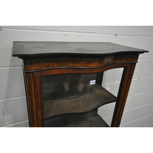 1212 - AN EDWARDIAN MAHOGANY SERPENTINE SINGLE DOOR DISPLAY CABINET, with a panel base, on square tapered l... 