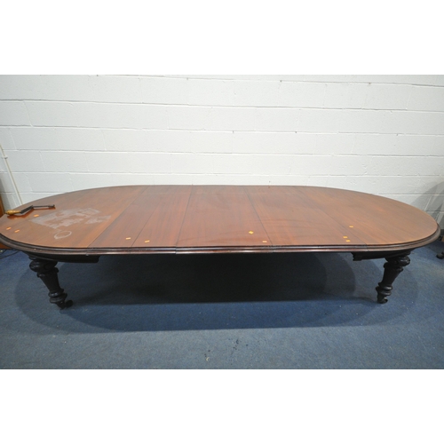 1223 - A VICTORIAN WALNUT WIND OUT DINING TABLE, with rounded ends, three additional leaves, on bulbous leg... 