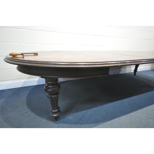 1223 - A VICTORIAN WALNUT WIND OUT DINING TABLE, with rounded ends, three additional leaves, on bulbous leg... 