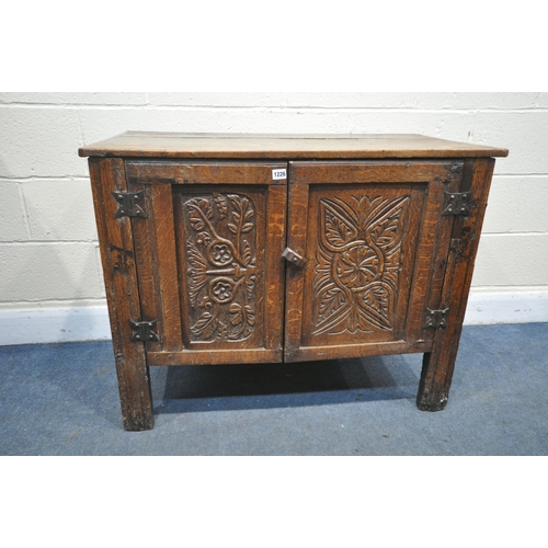 1226 - A CARVED OAK AND PANNELED TWO DOOR CUPBOARD, incorporating 18th century or earlier timbers, width 99... 