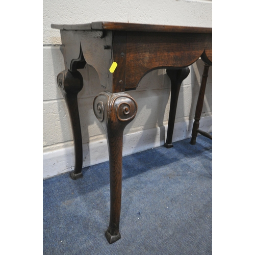 1227 - A GEORGIAN OAK RECTANGULAR TABLE, with plank top, shaped frieze, on cabriole legs with scrolled carv... 