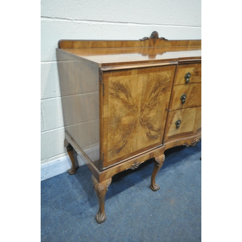 1235 - AN EARLY 20TH CENTURY QUEEN ANNE STYLE SERPENTINE WALNUT SIDEBOARD, with three central drawers flank... 