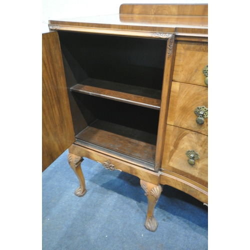 1235 - AN EARLY 20TH CENTURY QUEEN ANNE STYLE SERPENTINE WALNUT SIDEBOARD, with three central drawers flank... 