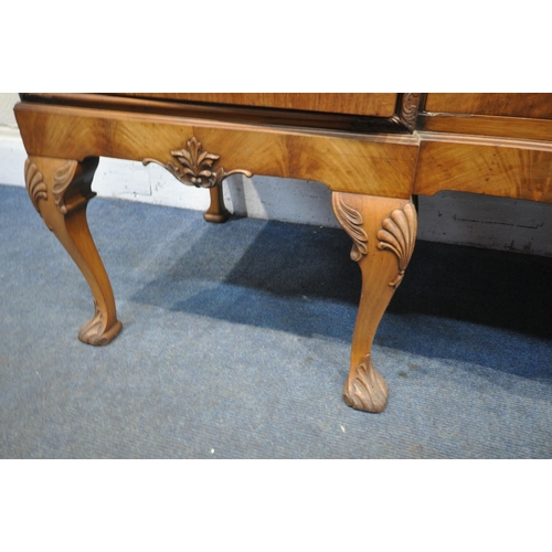 1235 - AN EARLY 20TH CENTURY QUEEN ANNE STYLE SERPENTINE WALNUT SIDEBOARD, with three central drawers flank... 