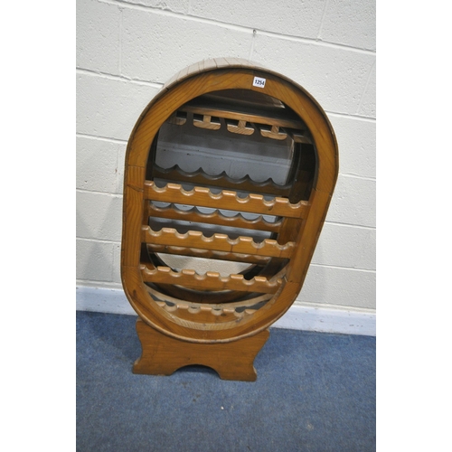 1254 - A PINE BARREL STYLE WINE RACK, with the capacity to house twenty-two wine bottles, and four wine gla... 